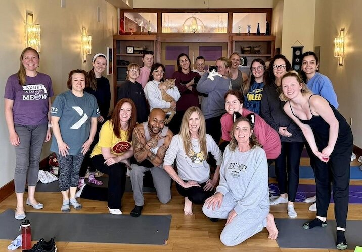 Jamie Bishop and participants are all smiles after kitten yoga.