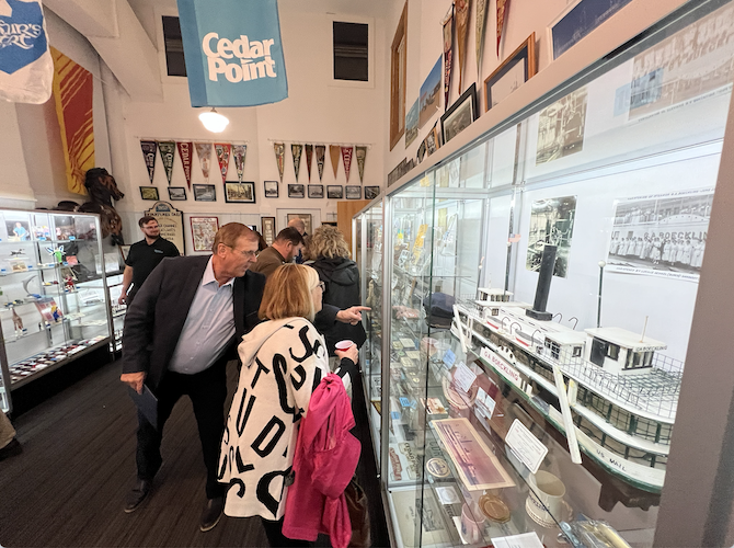 Kaman points out an exhibit during the VIP Preview.