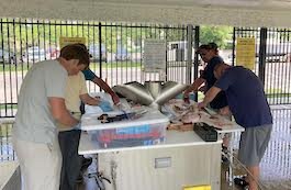 Anglers make use of the Mazurik Fish Cleaning Station. (Photo/Kristina Smith)