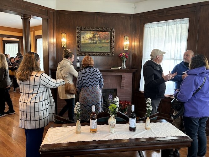 Guests mingle during the mansion's grand opening.