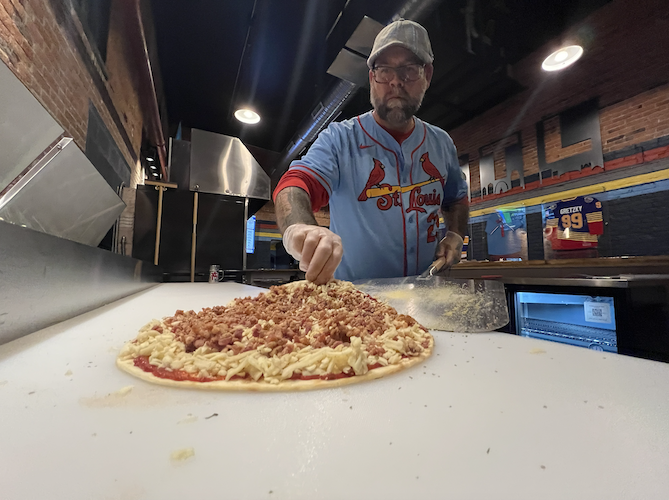 What makes a St. Louis-style pizza special is its cracker-like crust, Provel cheese, and semi-sweet sauce cut into squares.