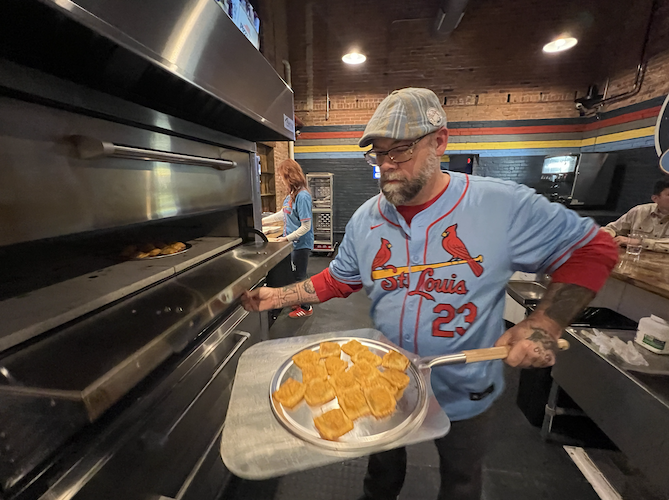 Jeremey prepares a batch of toasted ravioli for the oven.