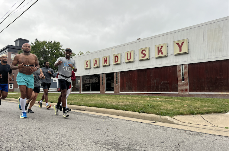 Johnson leads a group run down East Washington Street Aug. 6.