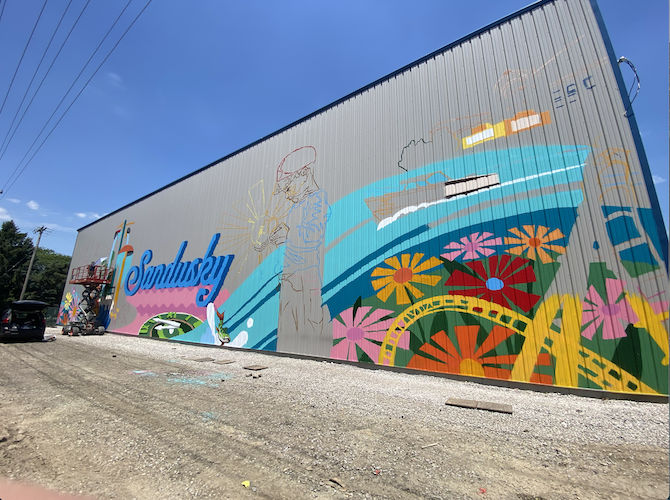 The mural features familiar Sandusky-centric items like a rollercoaster, a Lyman boat, and fish.