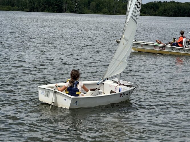 Children sail in opti boats at the Sandusky Sailing Club.