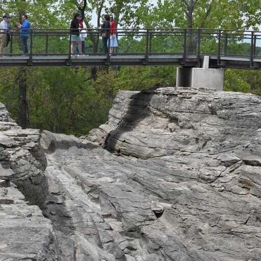 Visitors gather for the Glacial Grooves rededication ceremony in May 2023.